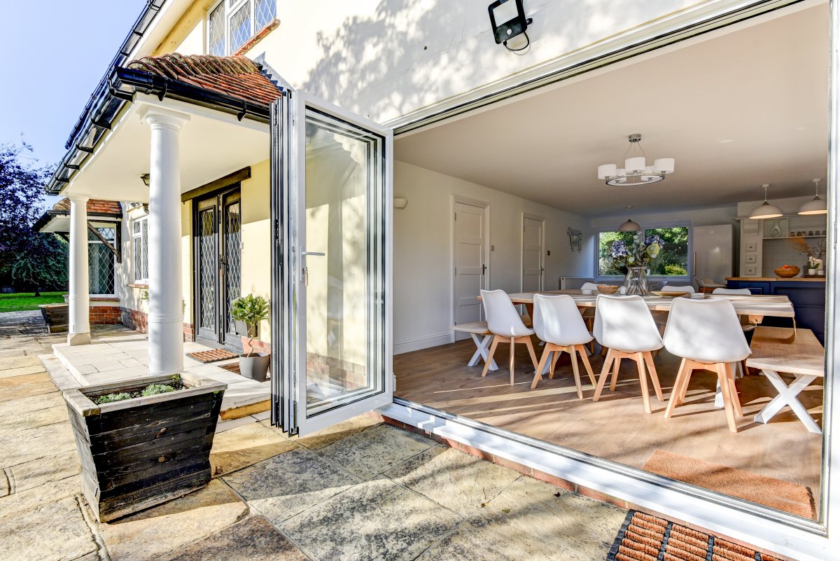 Bifold doors open the kitchen dining room out onto the patio